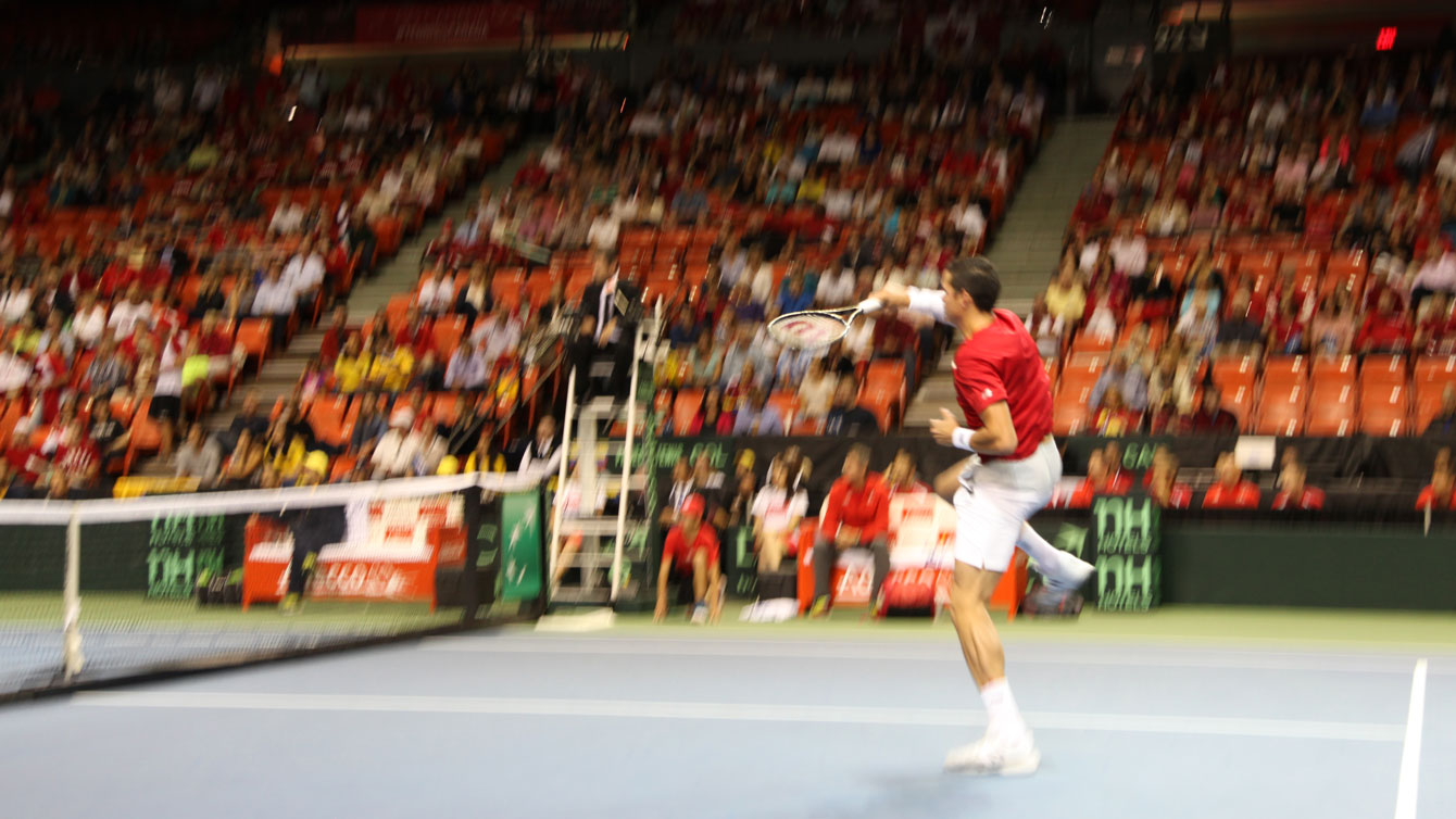 Raonic delivers an overhead volley to finish a first set rally against Gonzalez. 