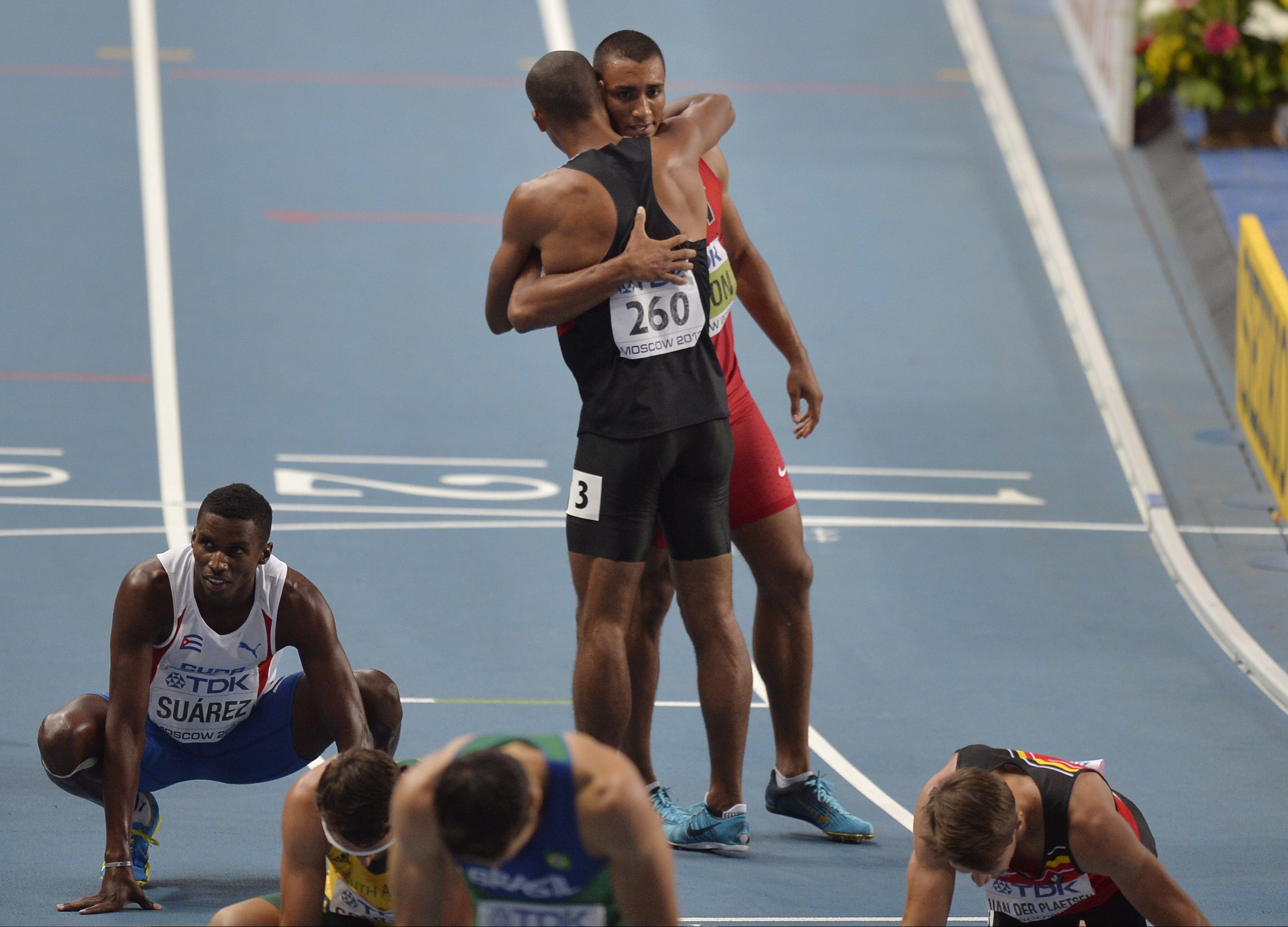 Damian Warner et Ashton Eaton se font une accolade aux Mondiaux d'athlétisme de 2013, le 11 août 2013 à Moscou. (AP Photo/Martin Meissner)