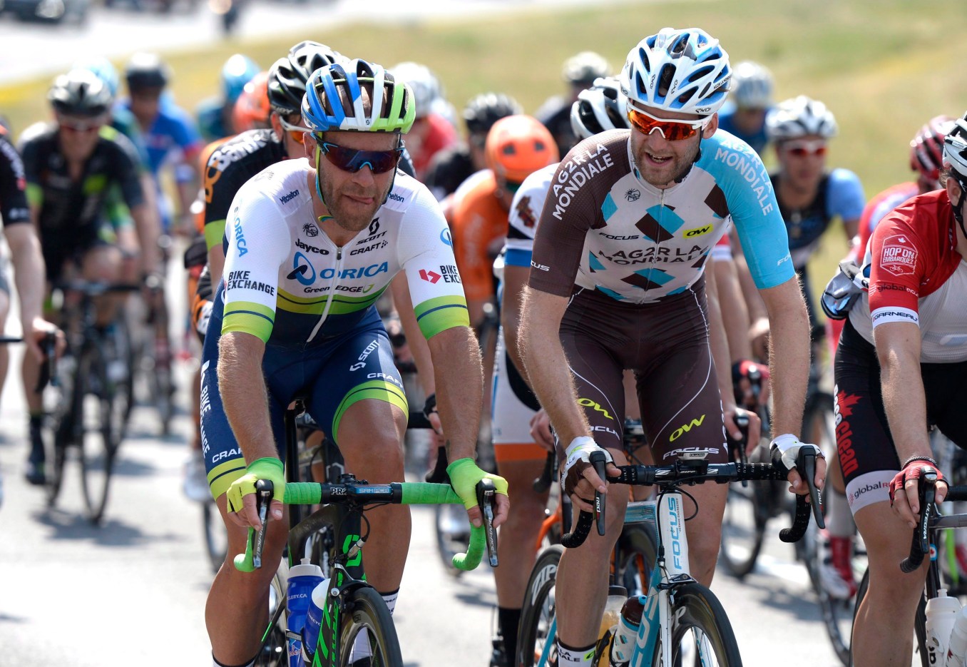 Svein Tuft, Hugo Houle UCI WorldTour riders Svein Tuft (left) and Hugo Houle talk as they ride in the peloton during the elite and under-23 cycling race at the Canadian Road Championships, Sunday, June 26, 2016 in Ottawa. THE CANADIAN PRESS/Justin Tang