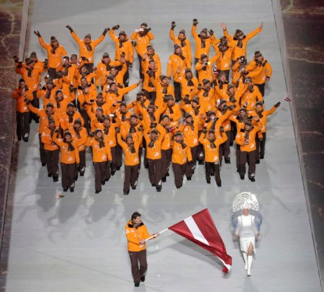 Sochi Olympics Opening Ceremony Sandis Ozolins of Latvia holds his national flag and enters the arena with teammates during the opening ceremony of the 2014 Winter Olympics in Sochi, Russia, Friday, Feb. 7, 2014. (AP Photo/Charlie Riedel)