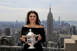 Bianca Andreescu montre son trophée, la ville de New York en arrière-plan