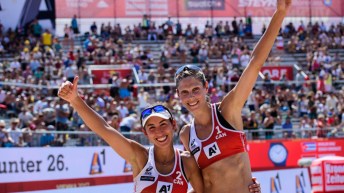 Deux joueuses de volleyball de plage sourissent avec les pouces en l'air