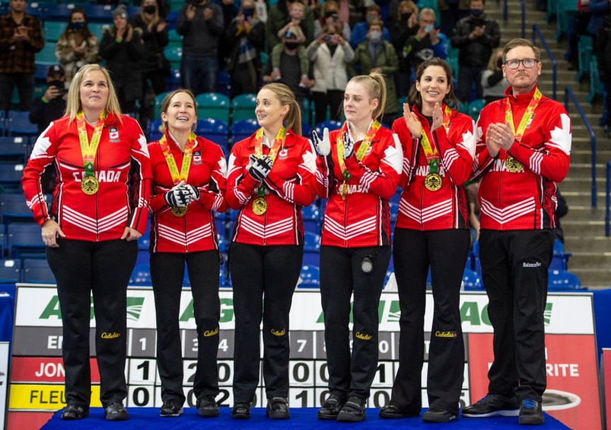 Les cinq membres d'Équipe Jones sur le podium avec leur entraîneur.