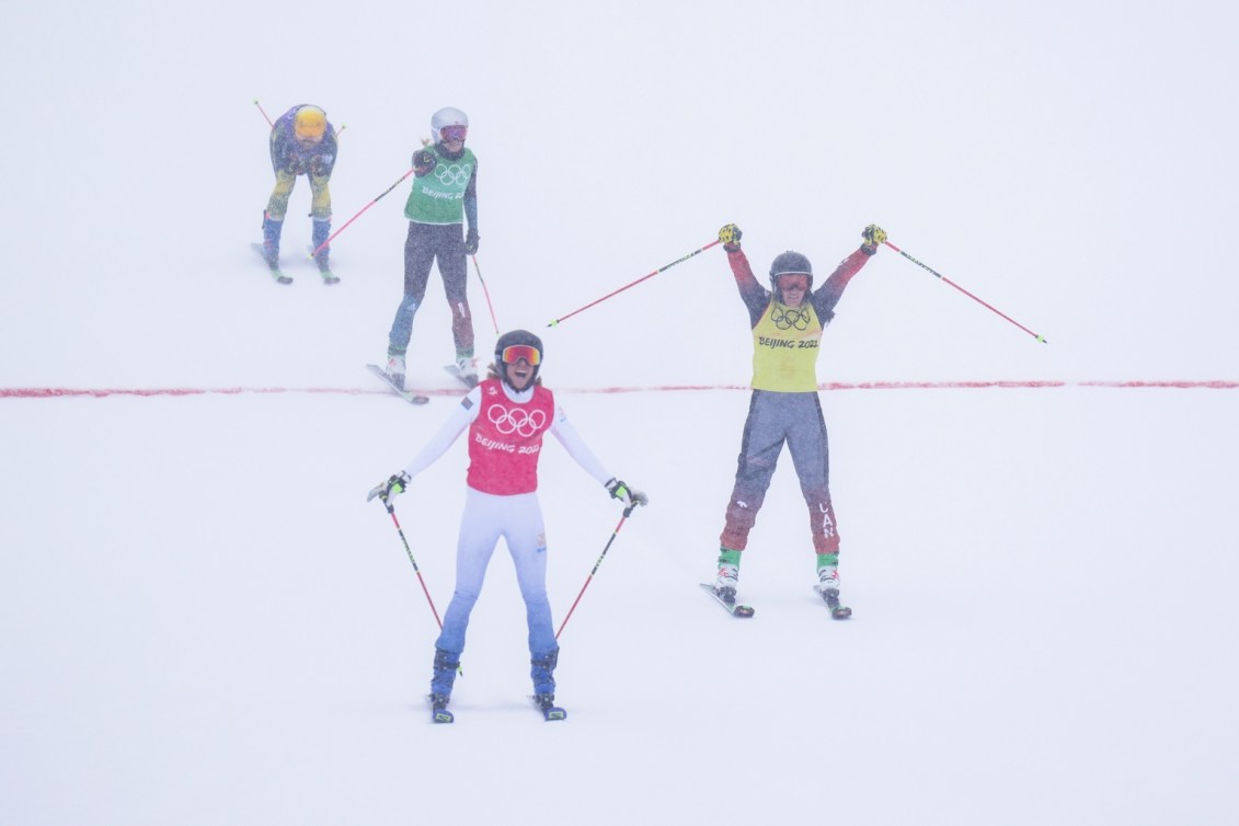 Marielle Thompson lève les mains en l'air avec ses bâtons après avoir franchie a ligne d'arrivée et avoir gagné l'argent en ski cross au ski acrobatique de Beijing 2022