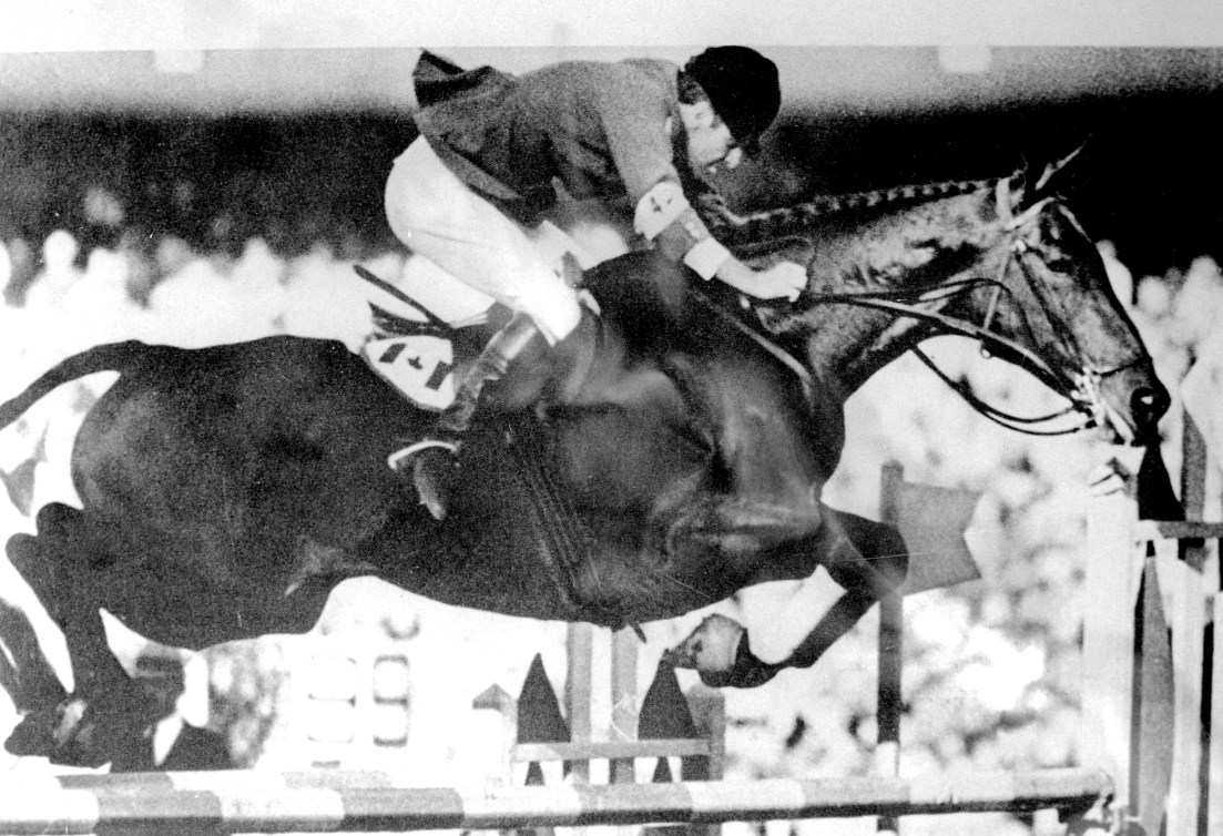 Photo en noir et blanc d'un cavalier sur un cheval.