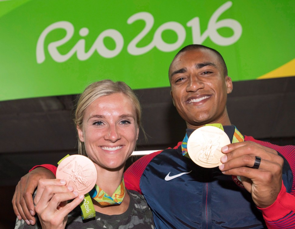 Deux athlètes posent avec leur médaille olympique.