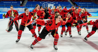 Canada's women's hockey team celebrates their gold medal