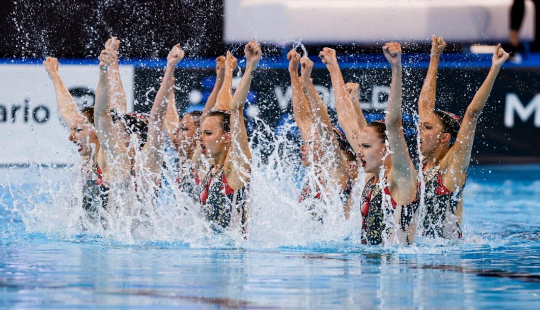 L'équipe entière de natation artistique du Canada sorte de l'eau pour faire une figure artistique