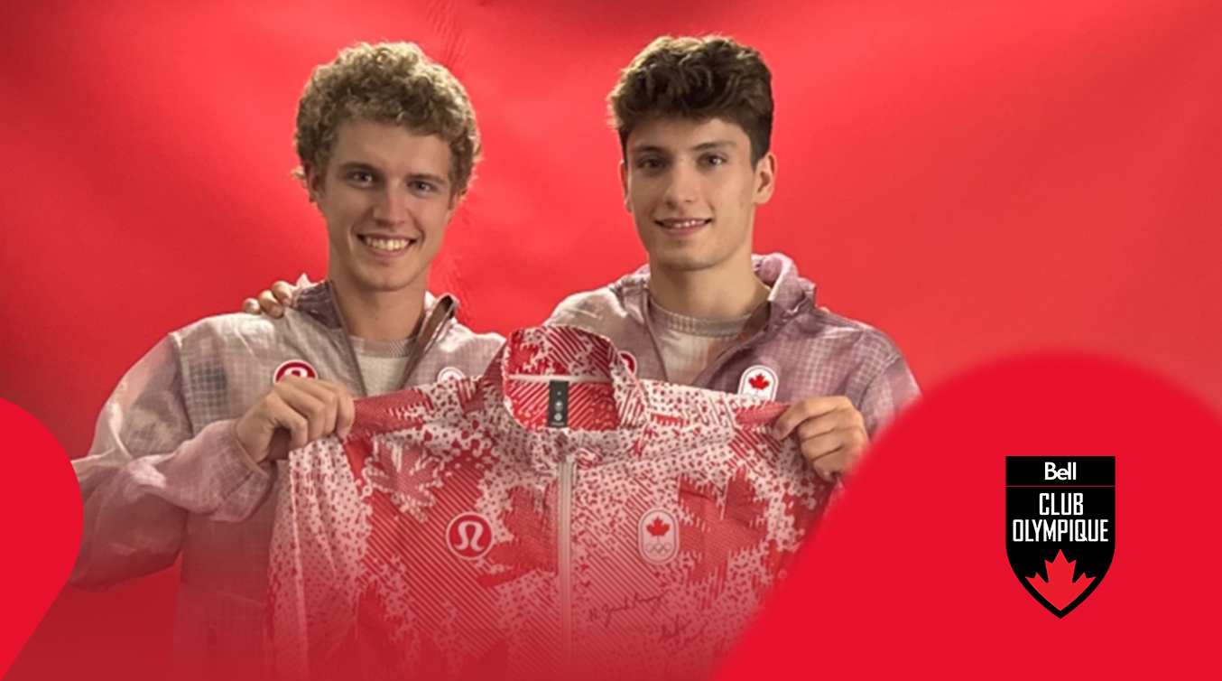 Athlete holding a signed Team Canada jacket