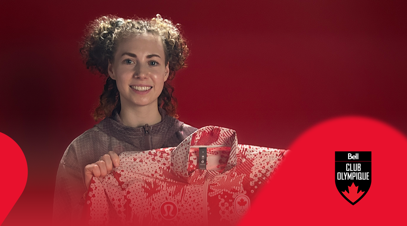Athlete holding a signed Team Canada jacket