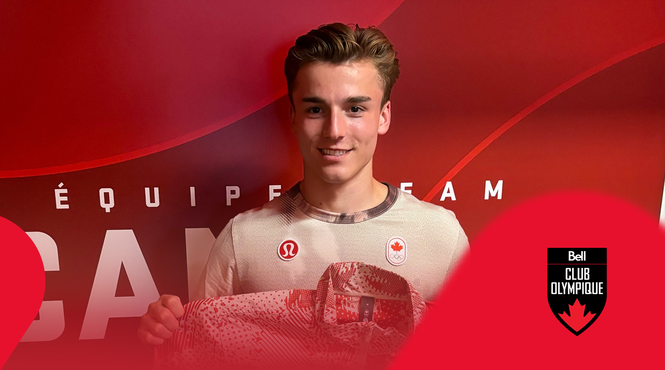 Athlete holding a signed Team Canada jacket