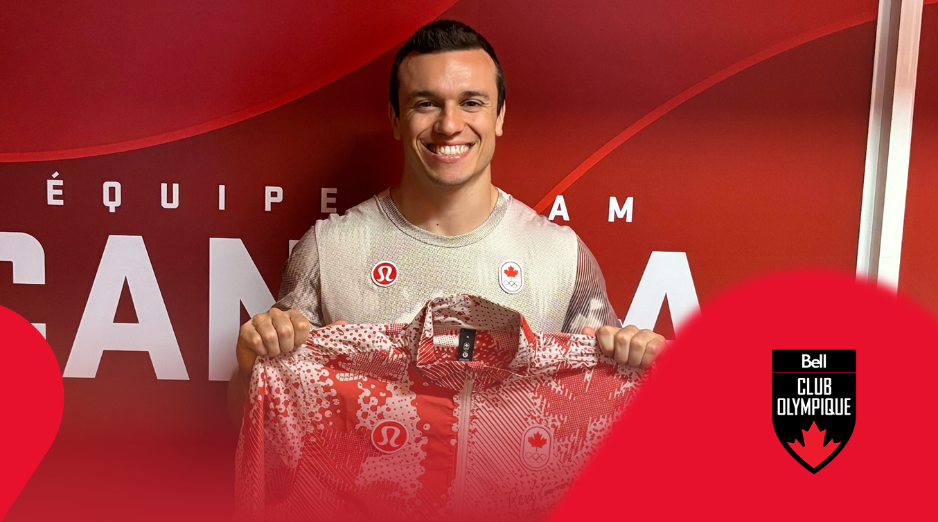 Athlete holding a signed Team Canada jacket