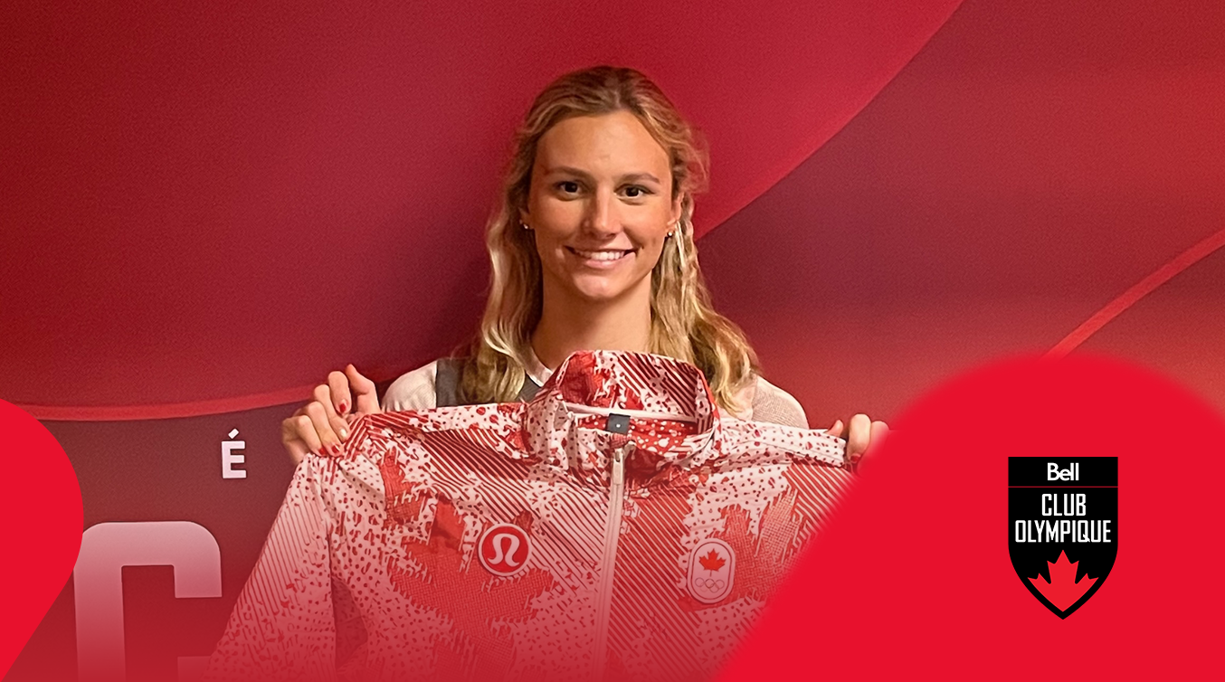 Athlete holding a signed Team Canada jacket