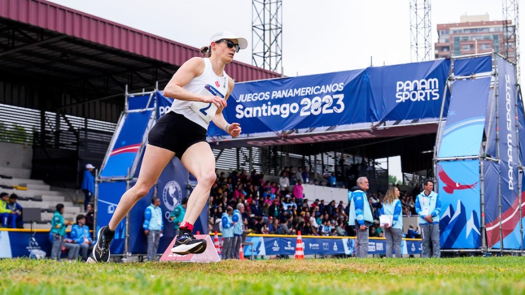 Canadian athlete runs on grass as part of a modern pentathlon competition