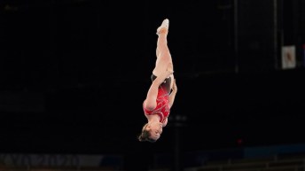 Rosie MacLennan upside down in the air while competing in trampoline
