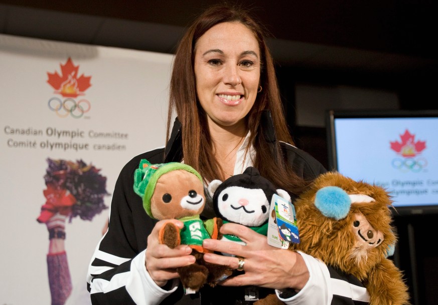 Nathalie Lambert holds the Vancouver 2010 mascots