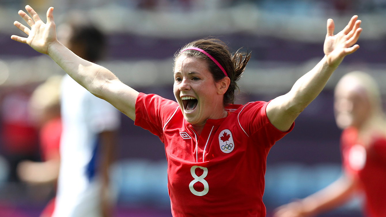 Matheson celebrates with her arms in the air