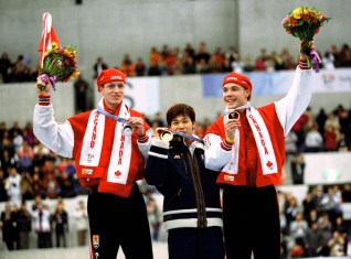 Canadians Jeremy Wotherspoon (left) and Kevin Overland (right) celebrate after winning respectively bronze and silver medals in the 500m long track speed skating event of the Nagano 1998 Olympic Winter Games.(CP PHOTO/COC)