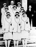 Canadian women athletes pose in suits with maple leaf on chest
