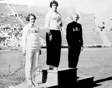 Three women stand on the podium