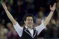 Patrick Chan smiling with his arms in the air