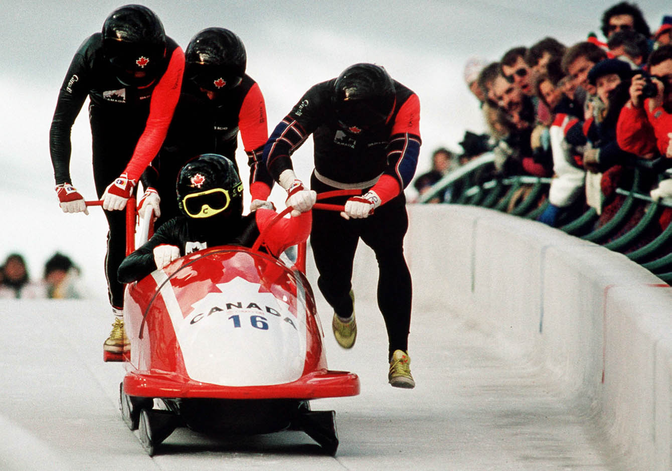 Four men running with bobsleigh