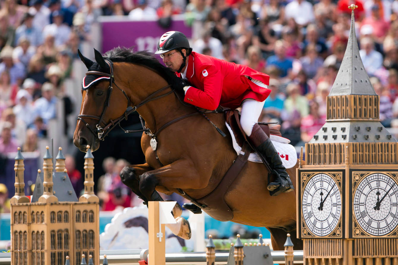 Canada's Ian Millar, from Perth, Ont., rides his horse Star Power over a jump in the first round of the Equestrian Individual Jumping final at London 2012, Wednesday, August 8, 2012. THE CANADIAN PRESS/Ryan Remiorz