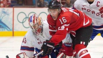 Jonathan Toews, ties to get a shot past Norway's goaltender Pal Grotnes