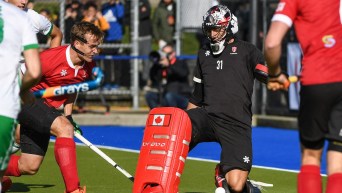 Field hockey goalie makes a save