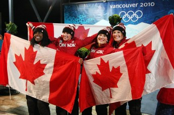 Kaillie Humphries and Heather of Canada celebrate their gold medal with teammates and silver medalists Helen Upperton and Shelley-Ann Brown during ladies 2 person bobsleigh at the 2010 Vancouver Olympic Winter Games in Whistler, B.C. THE (CANADIAN PRESS)2010(HO-COC-Dave Sandford)