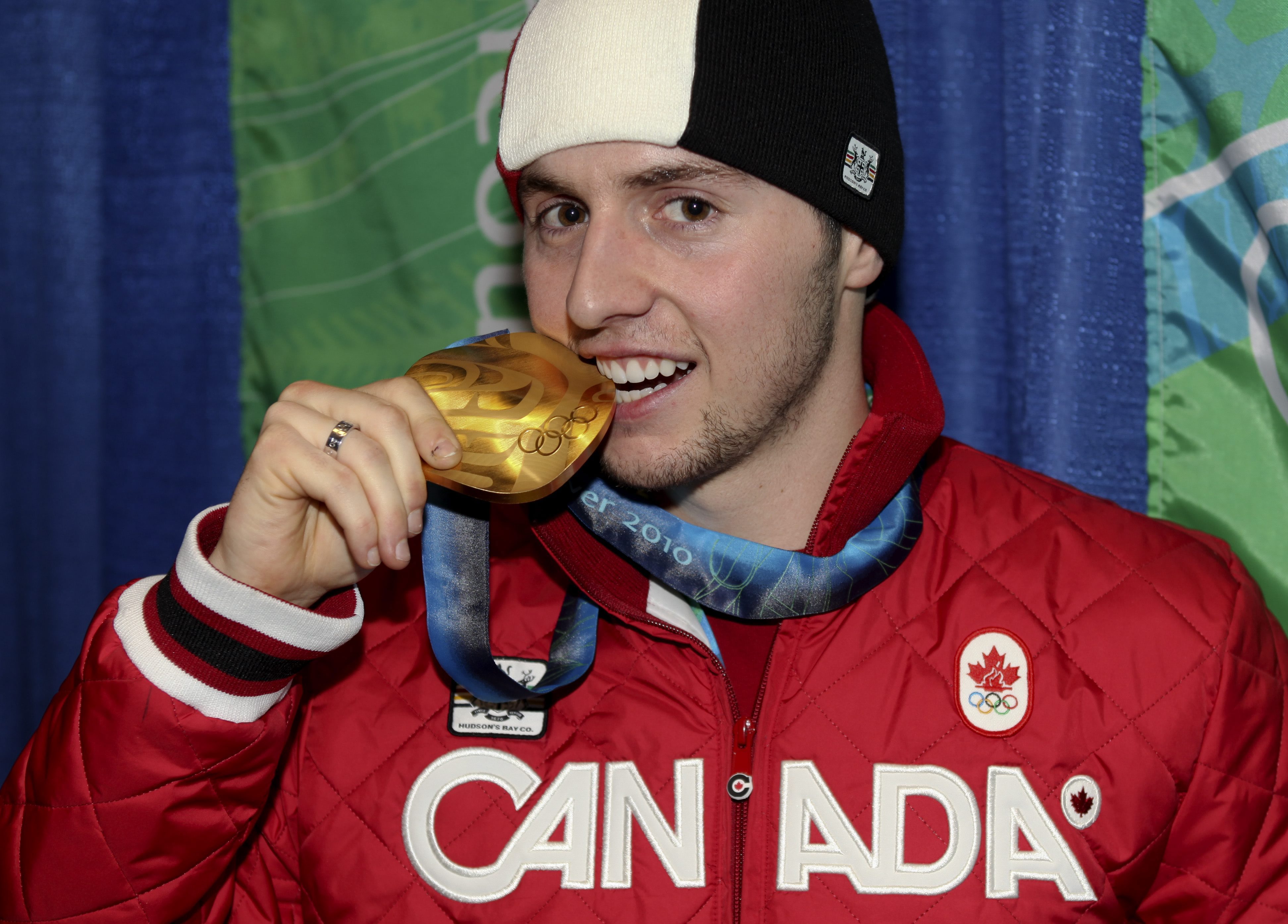 Alex Bilodeau of Rosemere, Que. with his gold medal for men's moguls at the Olympic Winter Games in Vancouver, B.C, Monday, Feb. 15, 2010. (CP PHOTO)(HO-COC-Mike Ridewood)