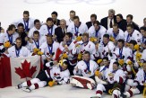 Team Canada captain Mario Lemieux and goalie Martin Brodeur are surrounded by teammates as they pose for a team photo after they won over Team USA to win the gold medal in hockey Sunday Feb. 24, 2002 at the 2002 Olympic Winter Games in Salt Lake City.