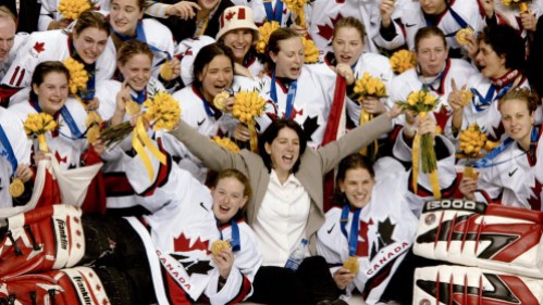 Ice Hockey - Women's Canadian women's hockey team coach Daniele Sauvageau (centre) and the Canadian women's hockey team pose for a team picture with their gold medal after defeating the United States 3 - 2 in Salt Lake City , Utah during the Winter Olympics, Thursday, Feb. 21, 2002. (CP PHOTO/COC/Mike Ridewood)