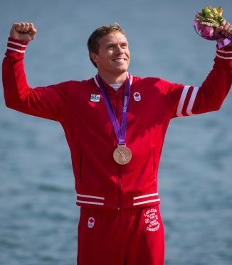 Mark de Jonge Mark de Jonge raises arms in celebration while wearing his medal