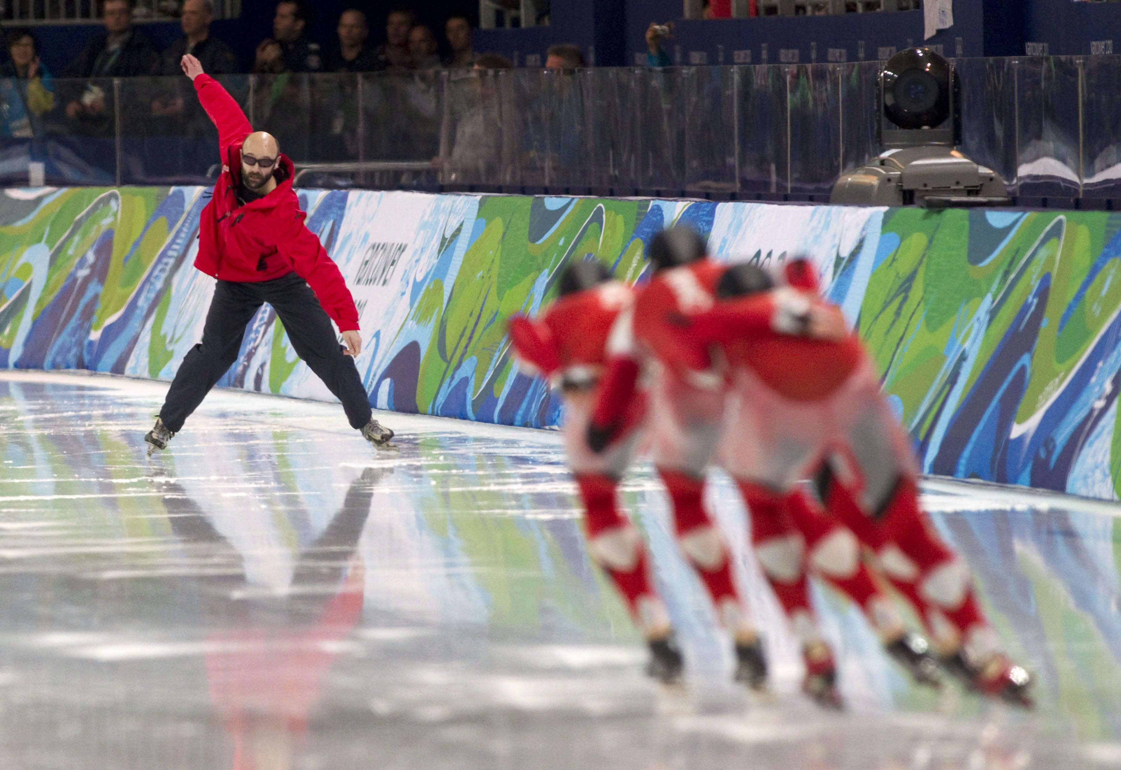 Coach Marcel Lacroix signals the men's team pursuit