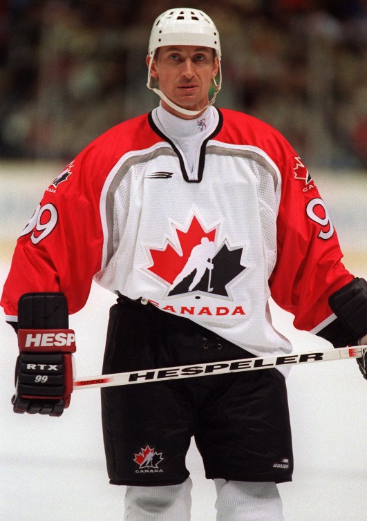 Wayne Gretzky stands on ice with stick in hands 