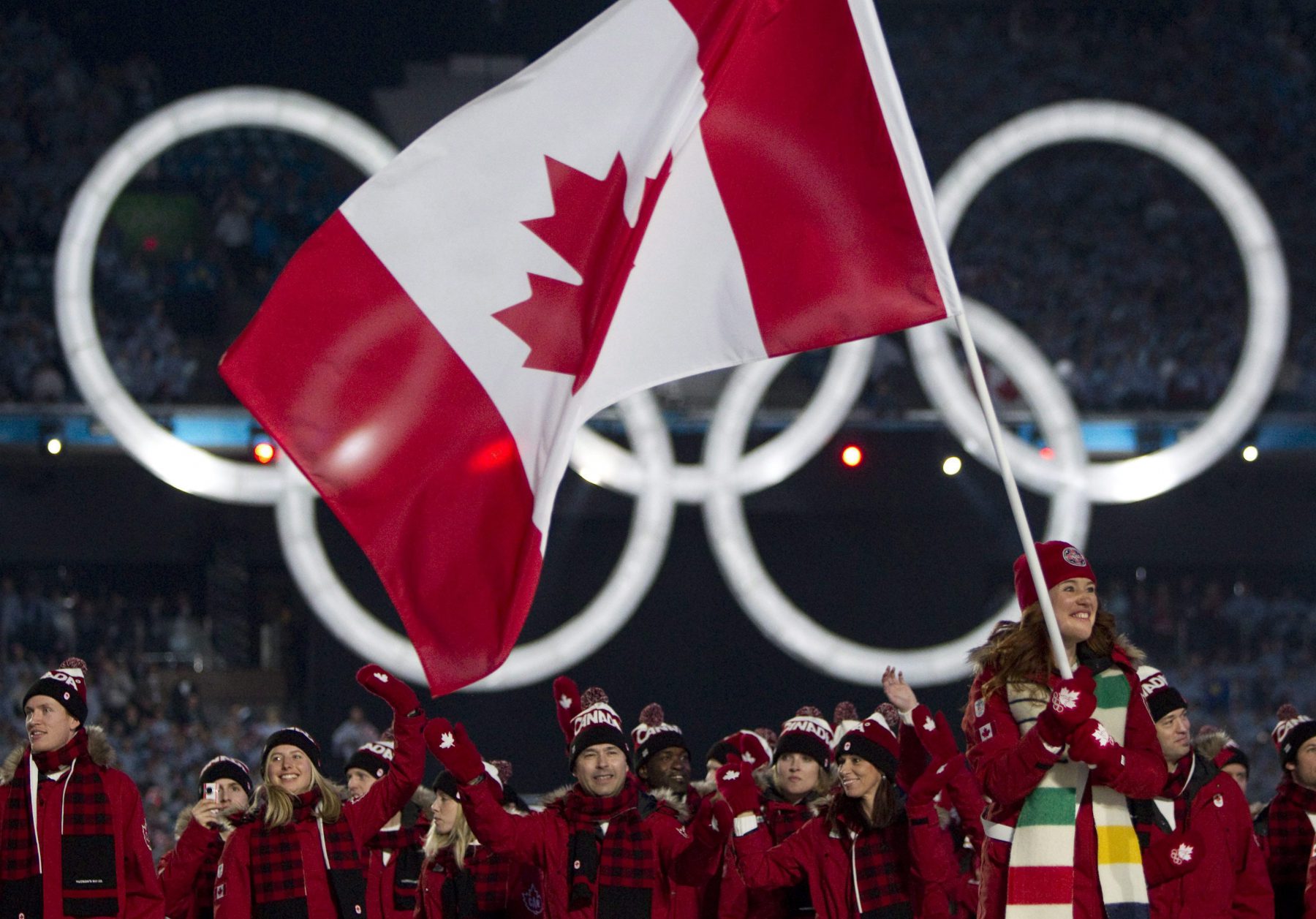 Canadian Olympic speed skater and cyclist Clara Hughes leads the Canadian team during the athlete's parade at the opening ceremony