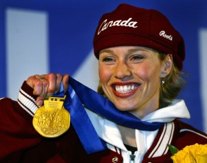 Canadian gold medallist in the women's 500m speed skating, Catriona Le May Doan, shows off her medal in Salt Lake City, Utah Friday Feb. 15, at the 2002 Olympic Winter Games. (CP PHOTO/HO/COC/Andre Forget)