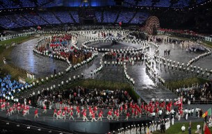 The Canadian Olympic team marches into the opening ceremony behind flag bearer Simon Whitfield at the 2012 London Olympics,