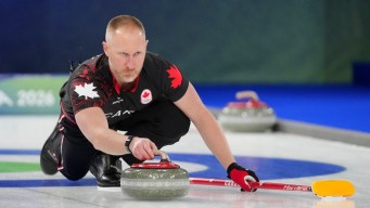Brad Jacobs throws a rock.