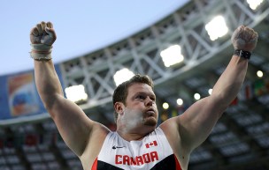 Armstrong celebrates with his arms in the air