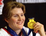 Canadian women's hockey team member Hayley Wickenheiser shows off her Olympic gold medal at a press conference in Calgary Wednesday Feb. 27, 2002. (CP PHOTO/Jeff McIntosh)
