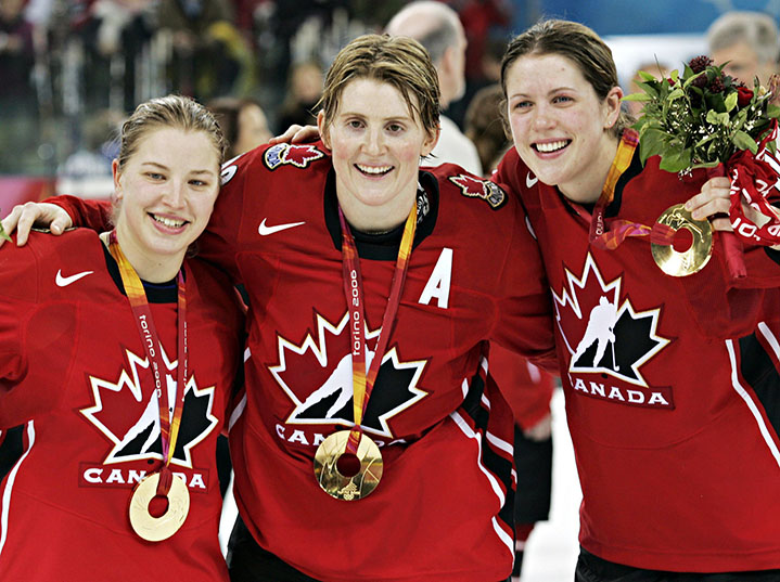 Team Canada's Colleen Sostrorics, left, Hayley Wickenheiser and Gillian Apps, right, celebrate after defeating Sweden 4-1 to win the gold medal in womens ice hockey at the 2006 Winter Olympic Monday, Feb. 20, 2006 in Turin. (CP PHOTO/Ryan Remiorz)
