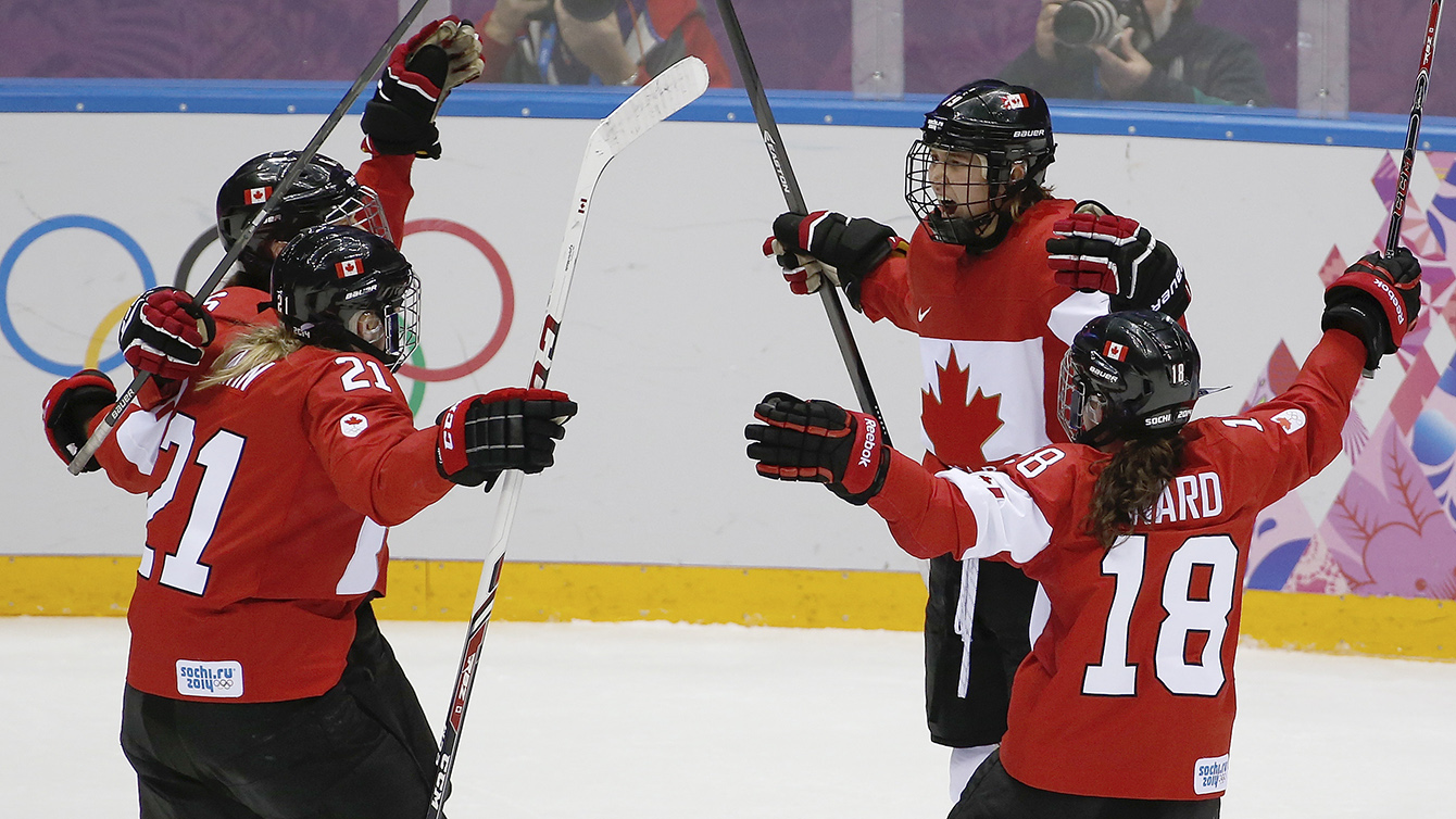 Team Canada celebrates beating Team USA in the gold medal women's hockey match