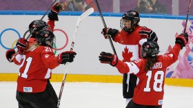 Team Canada celebrates beating Team USA in the gold medal women's hockey match
