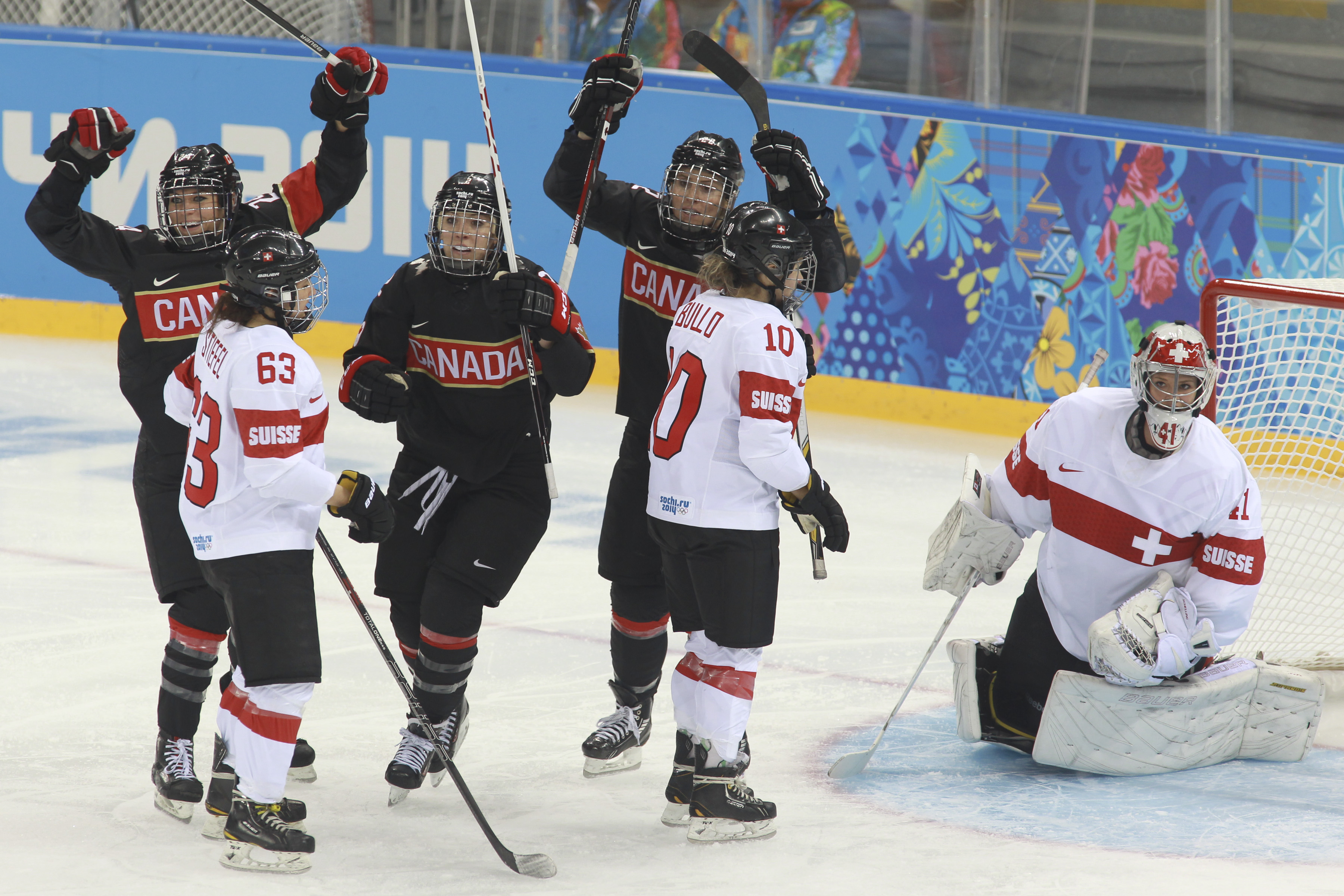 The Canadian women's hockey team celebrates after having defeated Switzerland 5 - 0