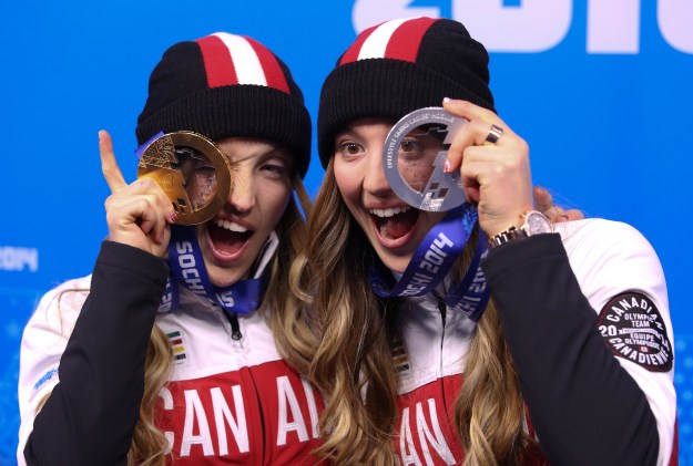 Justine Dufour-Lapointe receives her gold medal and her sister Chloe a silver