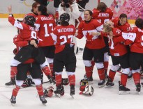 Team Canada celebrates beating Team USA in the gold medal women's hockey match