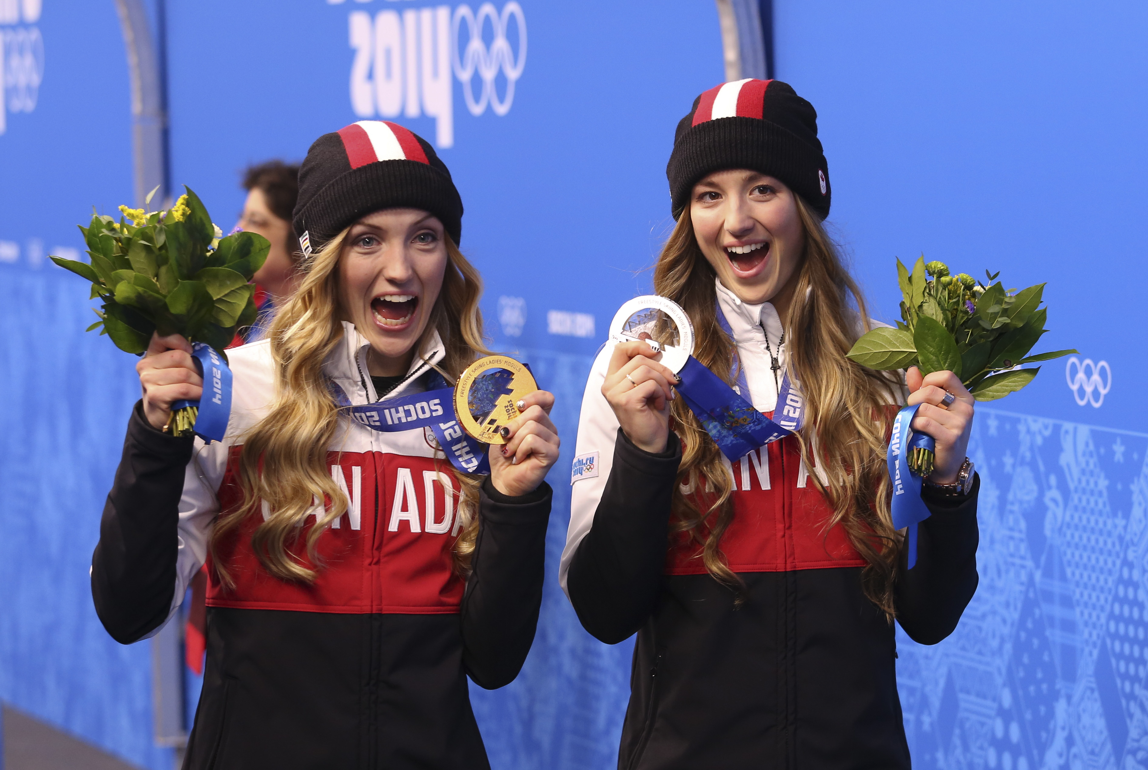 Justine Dufour-Lapointe receives her gold medal and her sister Chloe a silver
