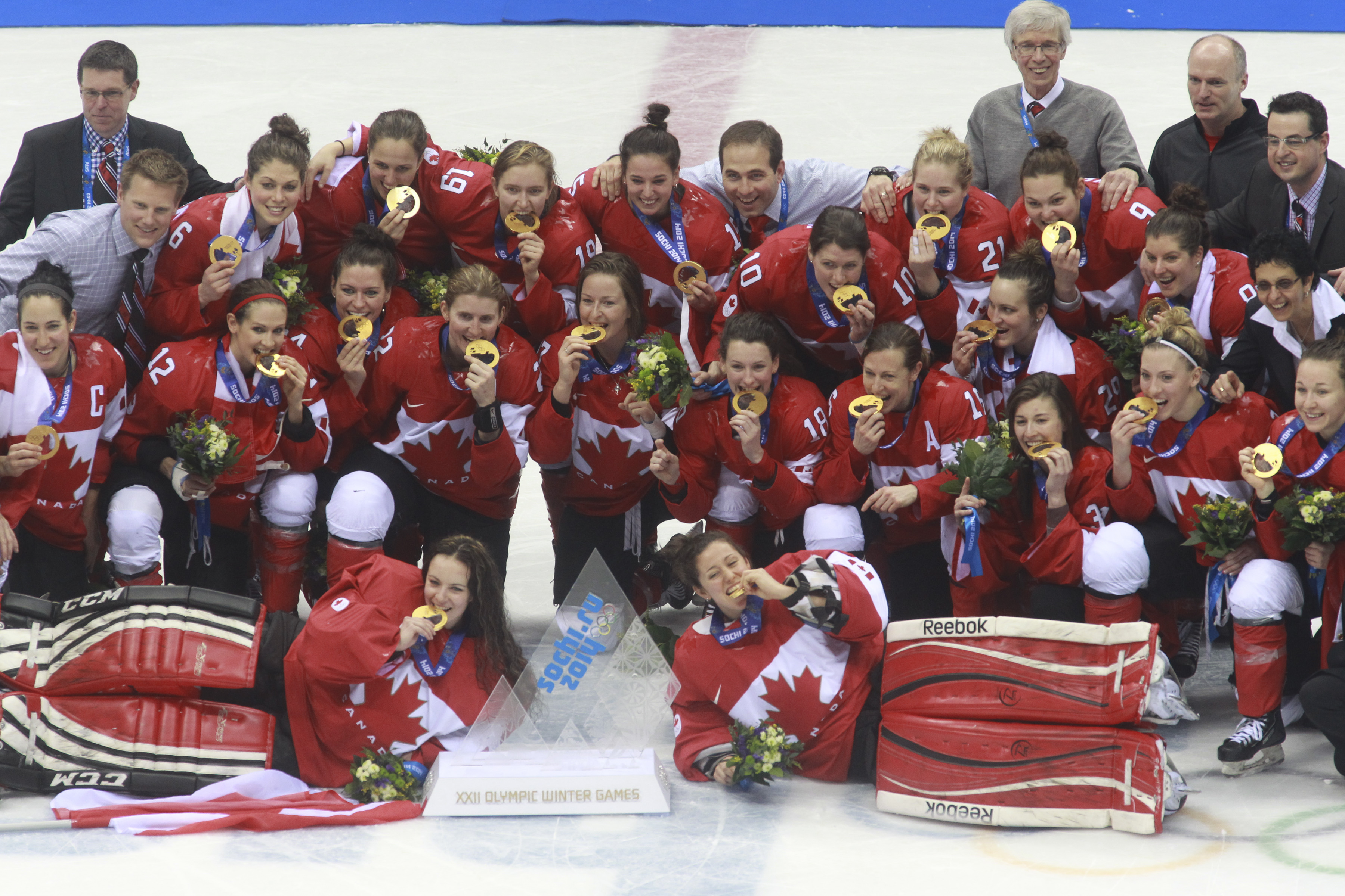 Team Canada celebrates beating Team USA in the gold medal women's hockey match